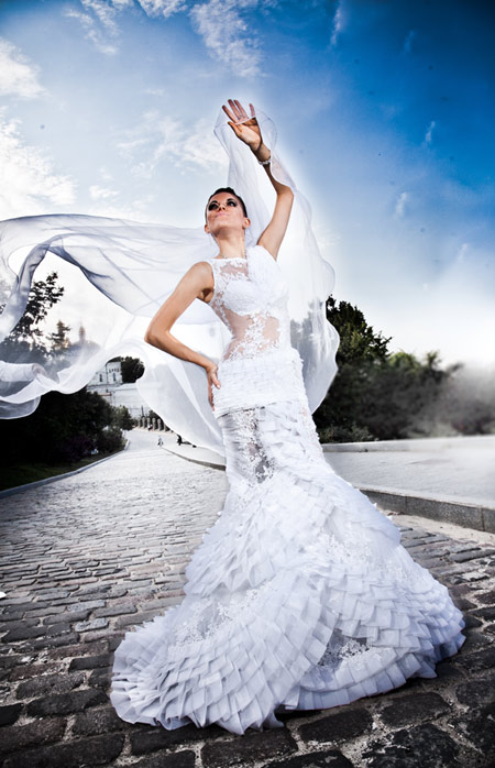 caucasian bride posing outdoor in white luxury dress