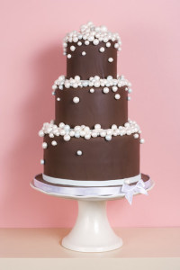 Three-tiered Chocolate Cake Against Pink Background